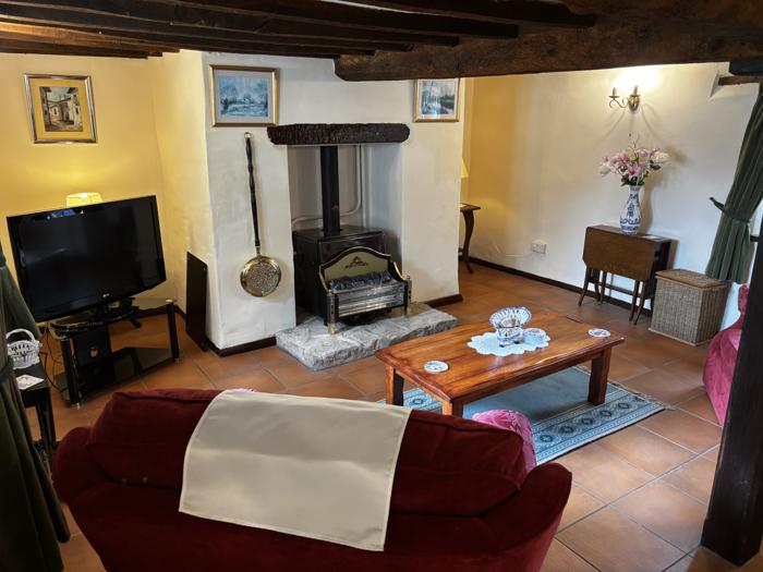 Sitting room with fireplace and beams